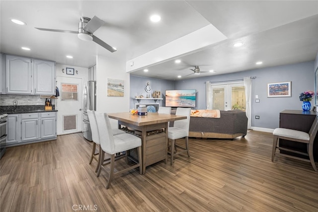 dining area featuring ceiling fan, french doors, and dark hardwood / wood-style flooring