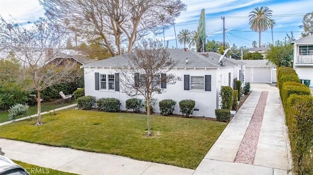 bungalow-style home with a front lawn