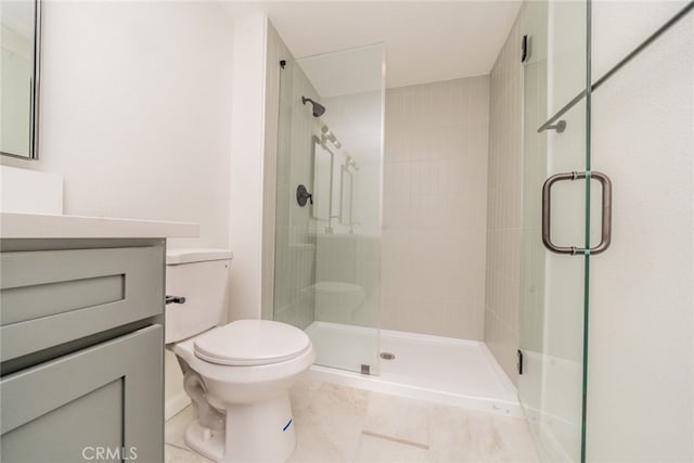 bathroom with tile patterned floors, an enclosed shower, vanity, and toilet