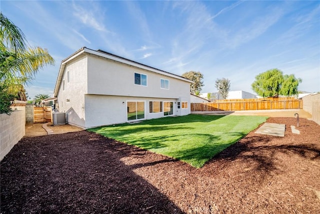 back of property with cooling unit and a lawn