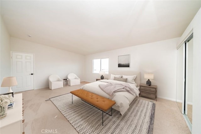 bedroom with light colored carpet, a closet, and vaulted ceiling