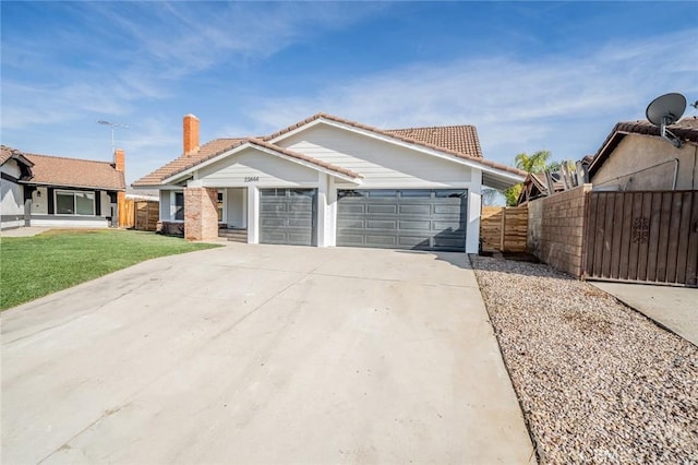 view of front of property featuring a front lawn and a garage