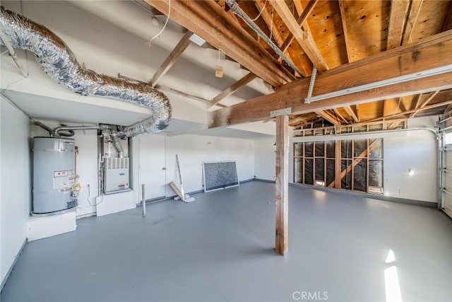 garage featuring heating unit and water heater