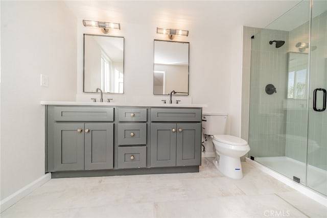 bathroom featuring toilet, a shower with door, and vanity