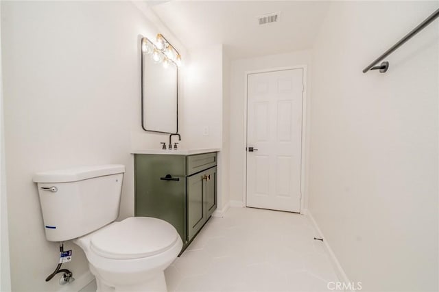 bathroom featuring tile patterned floors, vanity, and toilet