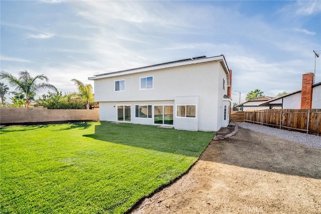 rear view of property with a yard