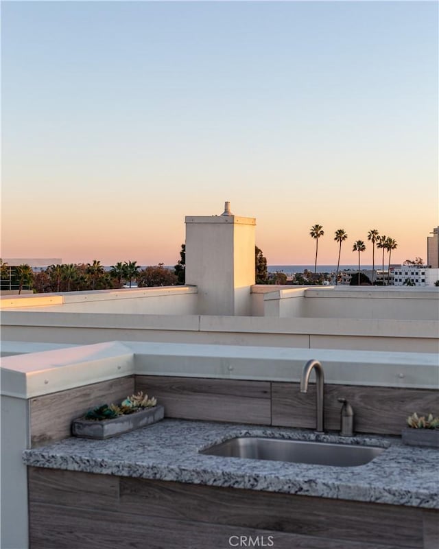 patio terrace at dusk featuring sink