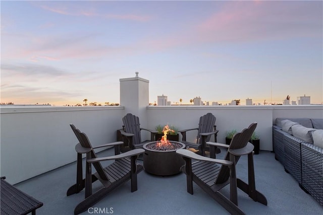 patio terrace at dusk with an outdoor fire pit