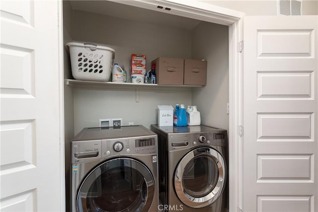 clothes washing area with washer and dryer