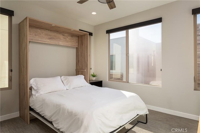 bedroom featuring ceiling fan and multiple windows