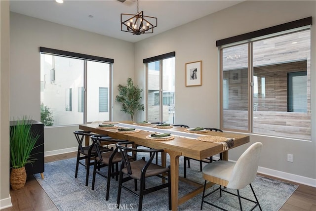 dining room with an inviting chandelier and wood-type flooring