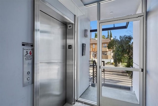 doorway to outside featuring elevator