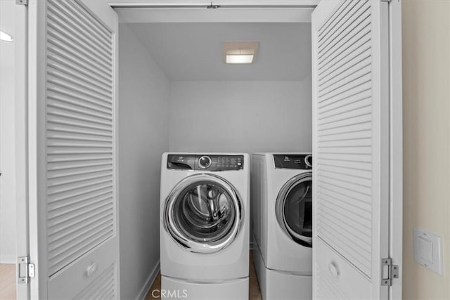 washroom featuring wood-type flooring and washer and clothes dryer