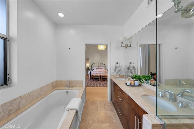 bathroom featuring tile patterned flooring, vanity, and a bathtub