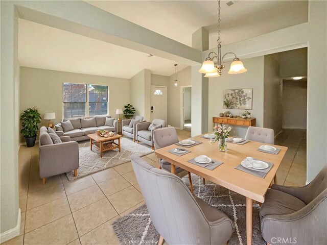 tiled dining area with an inviting chandelier