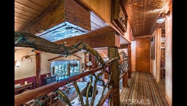 hallway with wooden ceiling and wooden walls