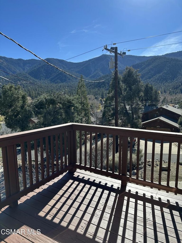 wooden deck featuring a mountain view