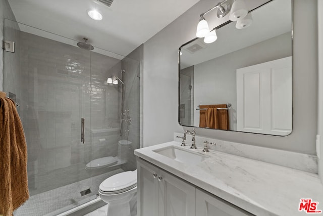 bathroom featuring toilet, an enclosed shower, and vanity