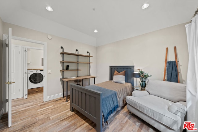 bedroom featuring washer / dryer and light hardwood / wood-style floors