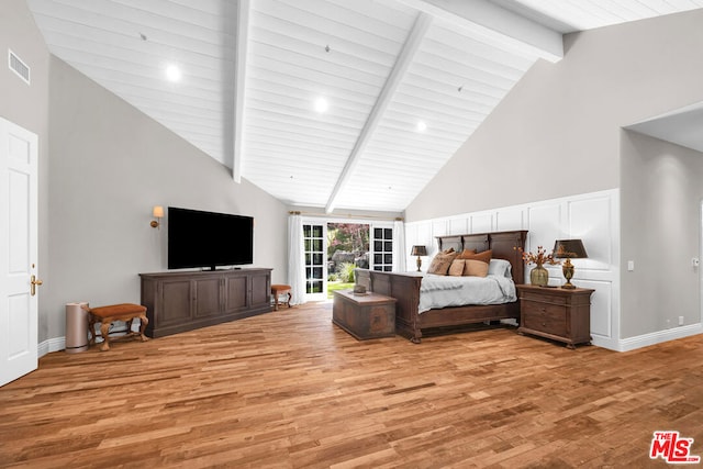 bedroom featuring high vaulted ceiling, light hardwood / wood-style flooring, and beamed ceiling