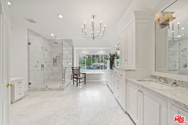 bathroom with vanity, a chandelier, and shower with separate bathtub