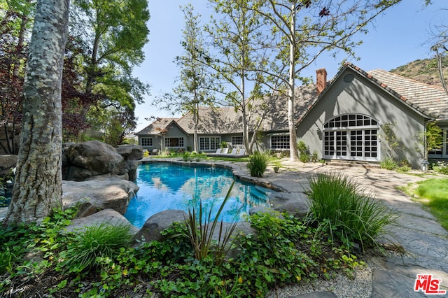 view of pool featuring french doors