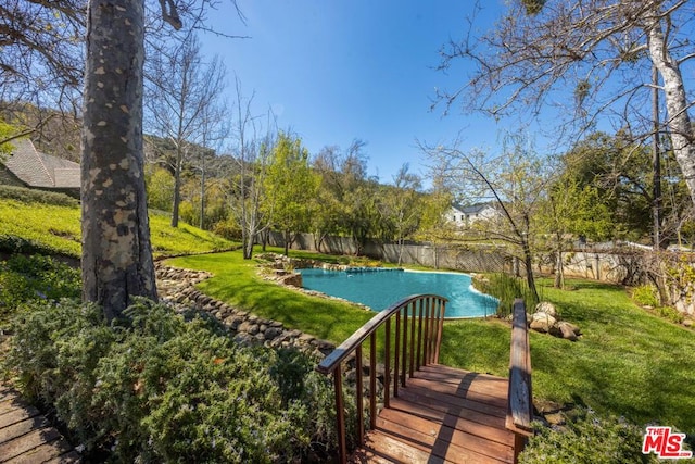 view of swimming pool featuring a lawn