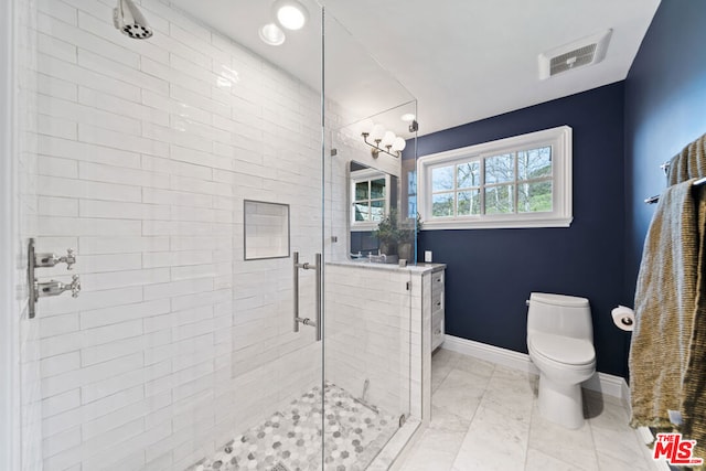 bathroom with toilet, tile patterned floors, and walk in shower