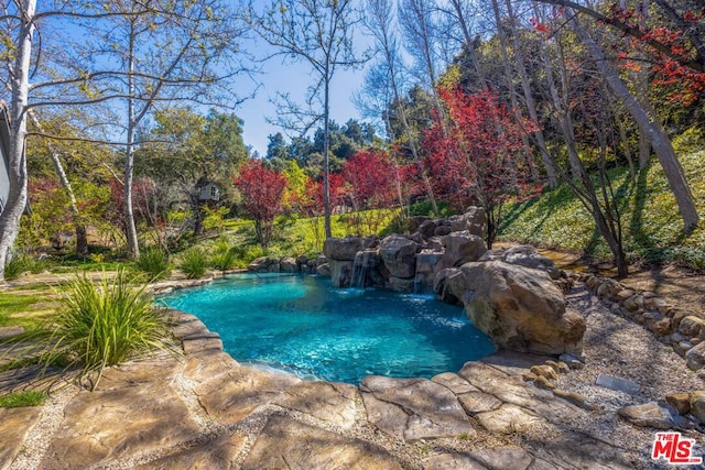 view of pool featuring pool water feature