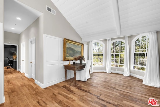 unfurnished sunroom featuring lofted ceiling and plenty of natural light