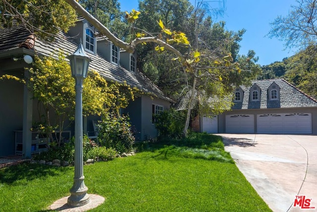 view of front of property with a front lawn and a garage