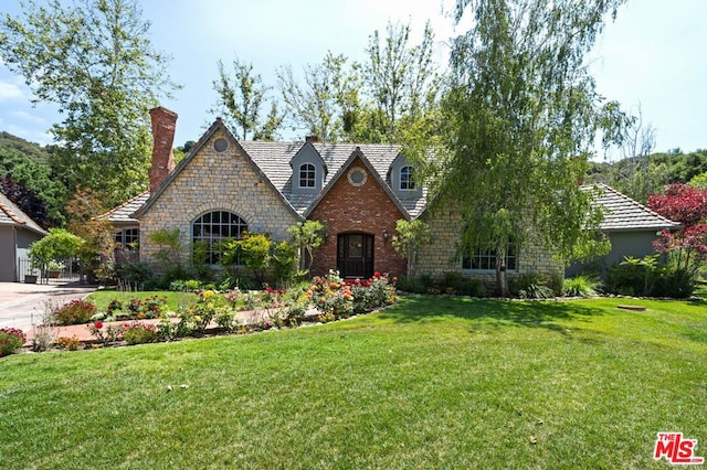 tudor house featuring a front yard