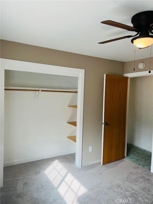 unfurnished bedroom with carpet flooring, ceiling fan, and a closet