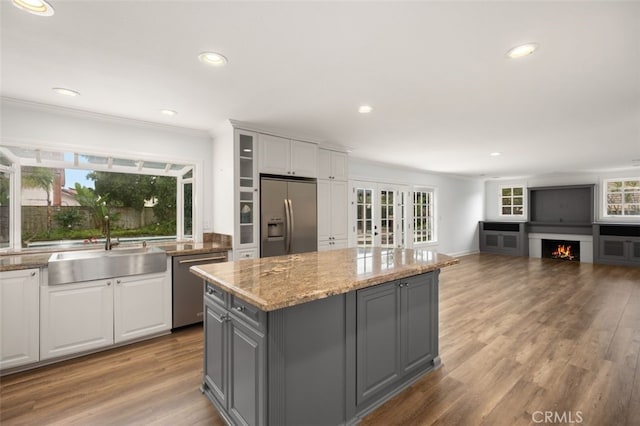 kitchen with sink, white cabinetry, a center island, gray cabinets, and stainless steel appliances