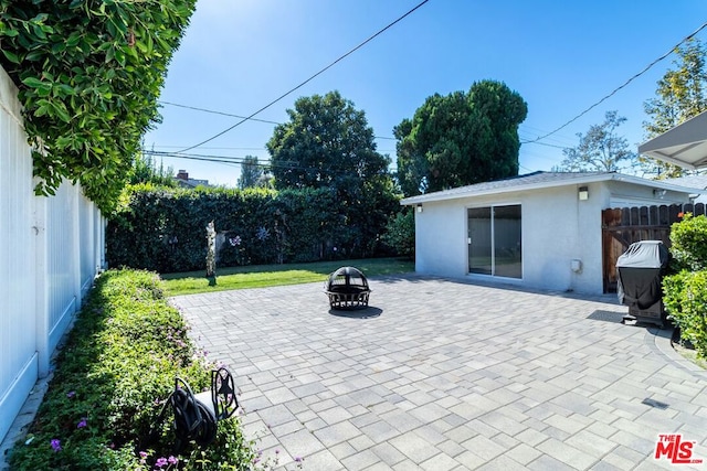 view of patio / terrace featuring an outdoor fire pit