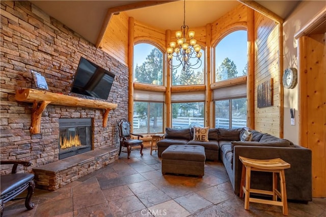 living room with a chandelier, a fireplace, and a high ceiling