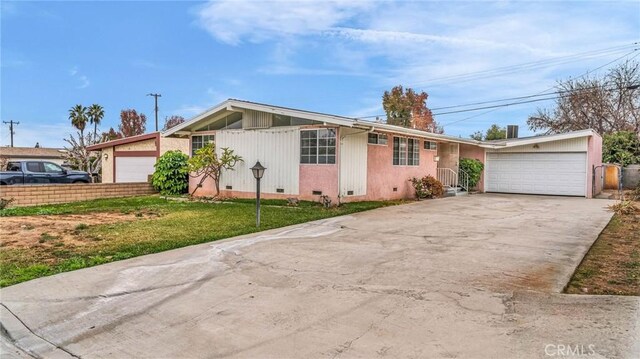 single story home featuring a garage and a front yard