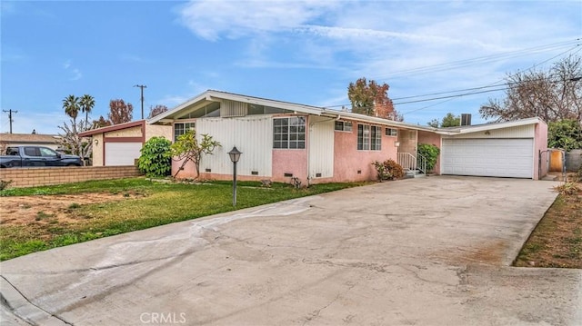 ranch-style home with a front yard and a garage