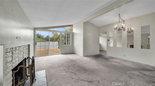 living room with carpet, lofted ceiling, a chandelier, and a stone fireplace