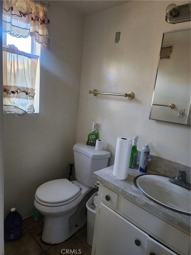 bathroom featuring toilet, vanity, and tile patterned floors