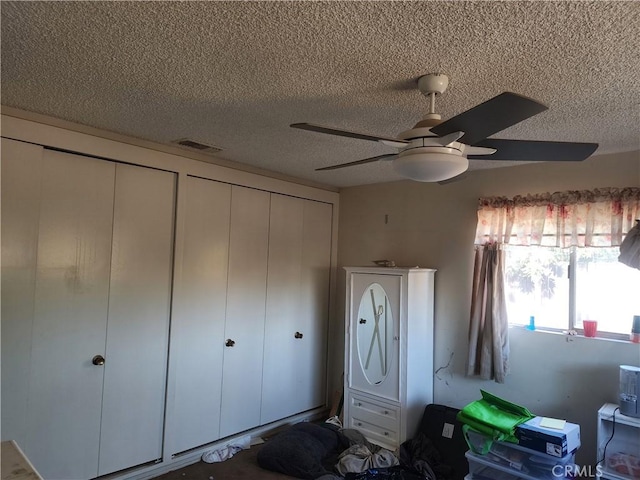 unfurnished bedroom with a textured ceiling and ceiling fan