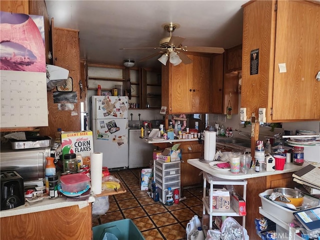 kitchen with ceiling fan, kitchen peninsula, dark tile patterned flooring, and white refrigerator