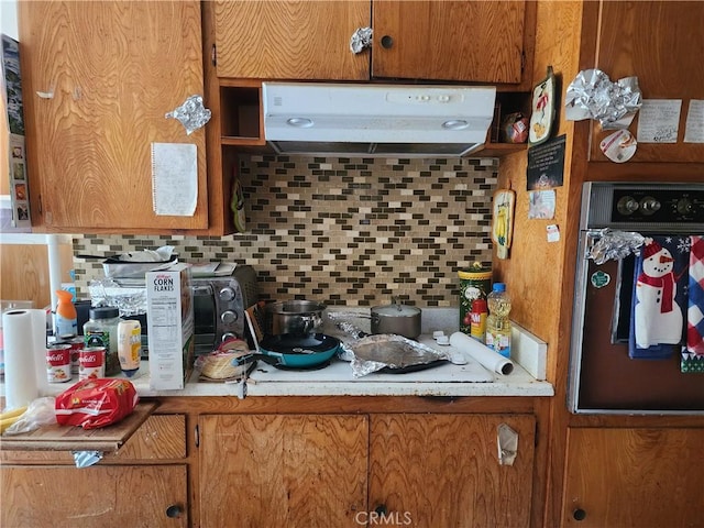 kitchen featuring tasteful backsplash and oven