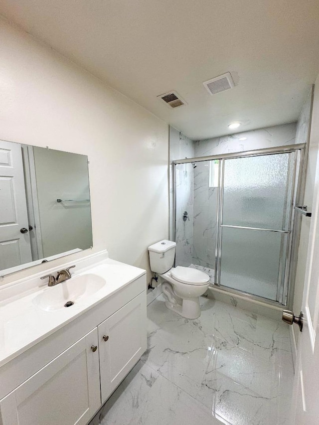 bathroom with an enclosed shower, vanity, and toilet