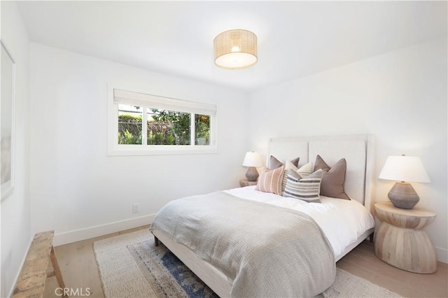 bedroom with hardwood / wood-style floors