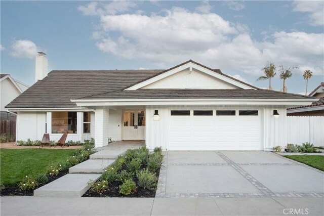 single story home with a garage and a front yard