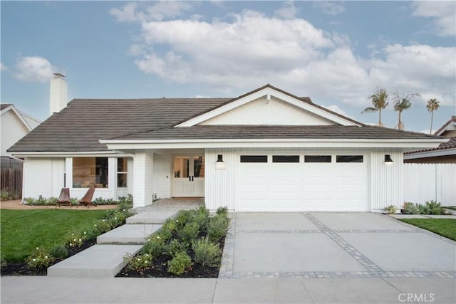 ranch-style home with a garage and a front yard