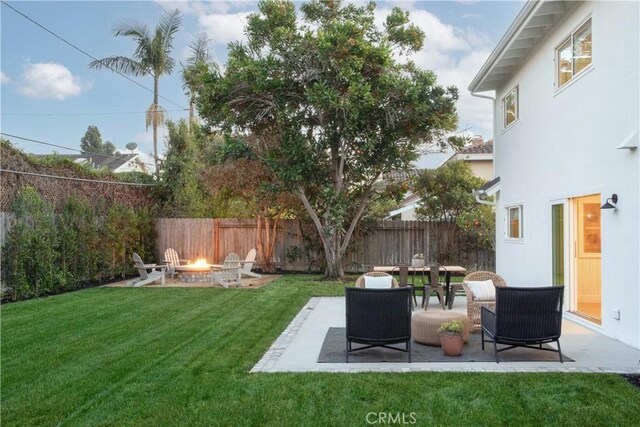 view of yard with an outdoor fire pit and a patio