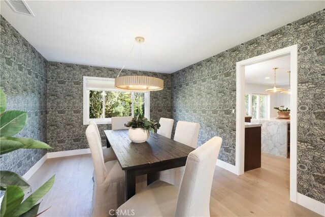 dining area with a healthy amount of sunlight and hardwood / wood-style floors