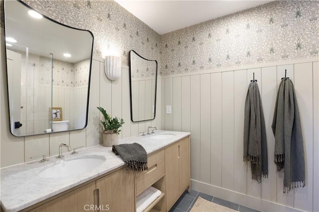 bathroom with a shower, tile patterned floors, and vanity